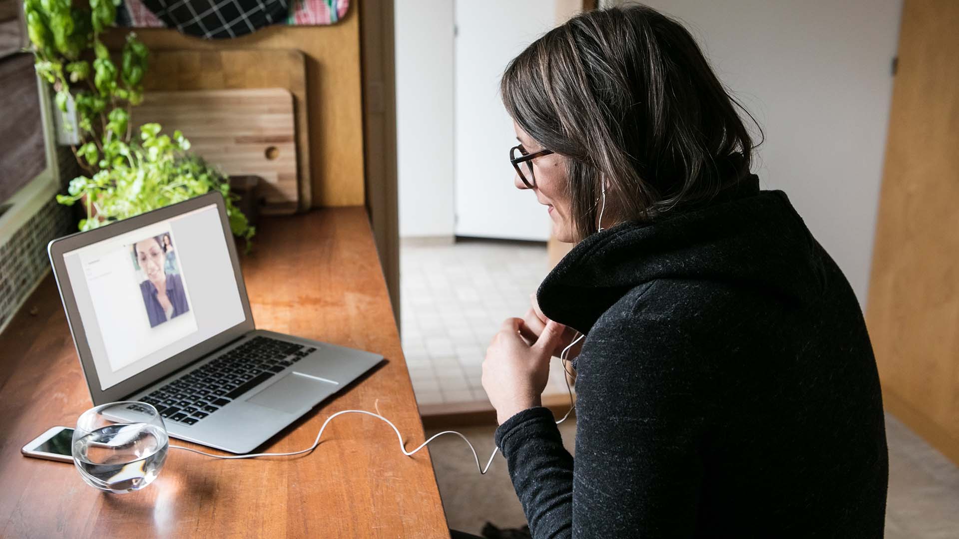 Woman sitting at desk looking at computer screen