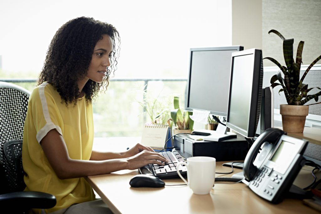 Businesswoman looking at computer screen in an office