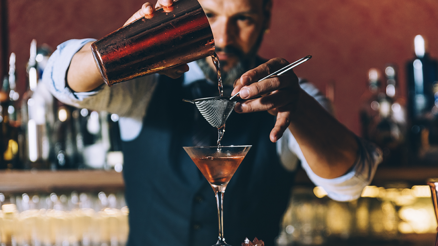 Photo of a man mixing a cocktail