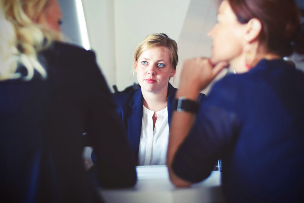 A young person interviewed by two older female professionals