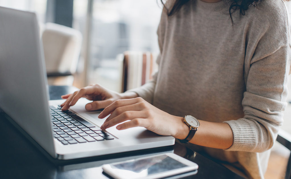 Person typing on laptop on desk