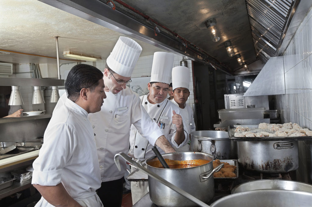 Chefs cooking in a commercial kitchen