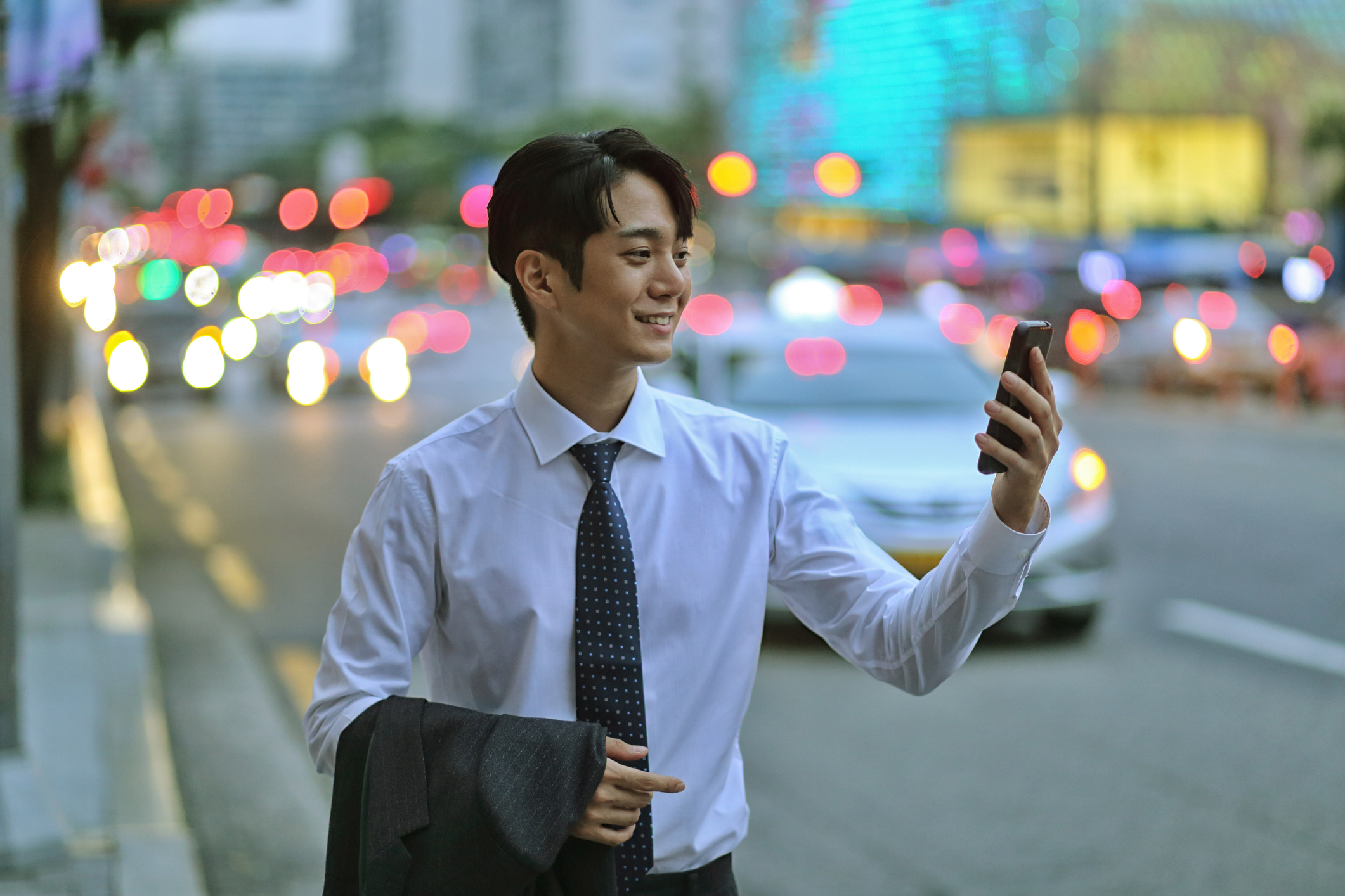 Businessman walking and looking at his phone