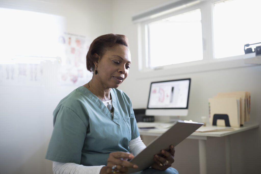 Health care professional reviewing medical record in office