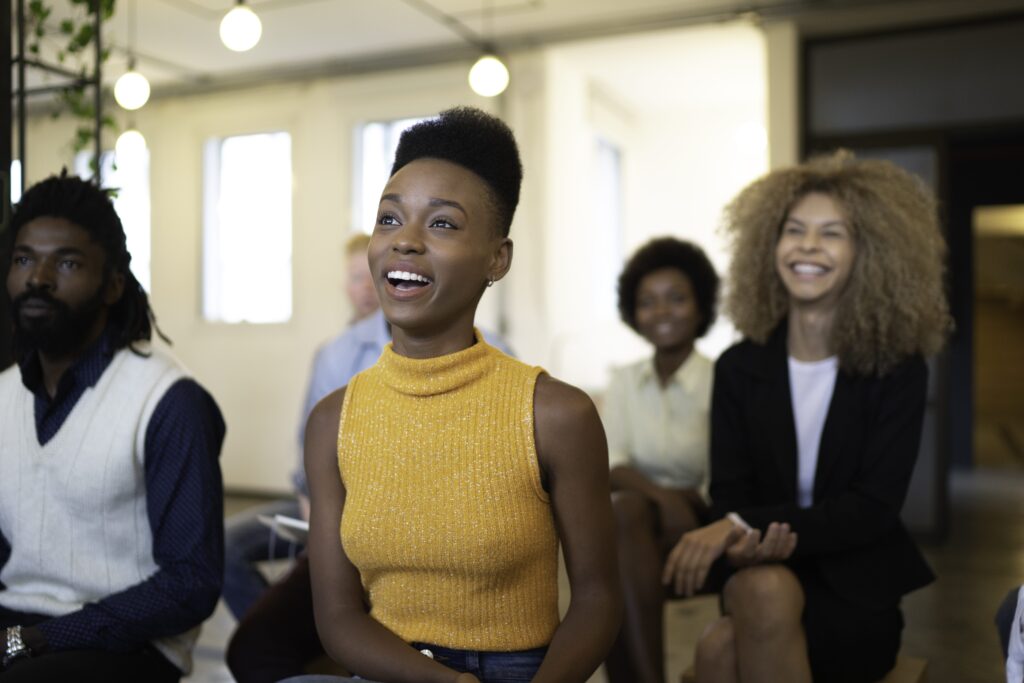 Young smiling people in the audience at a business and tech convention