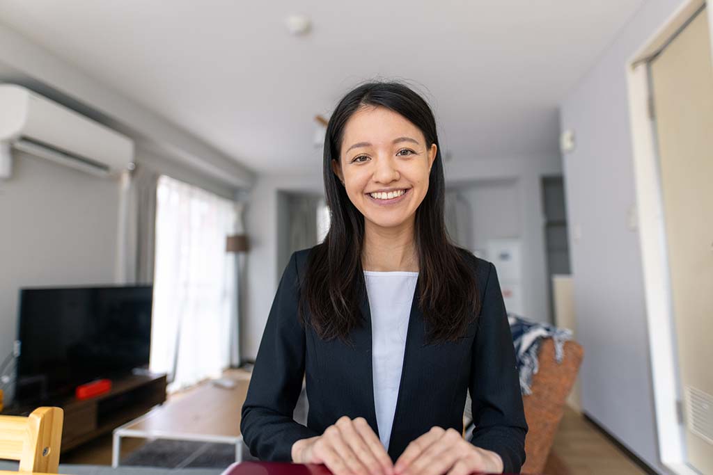 Business woman wearing suits and joining virtual interview from home