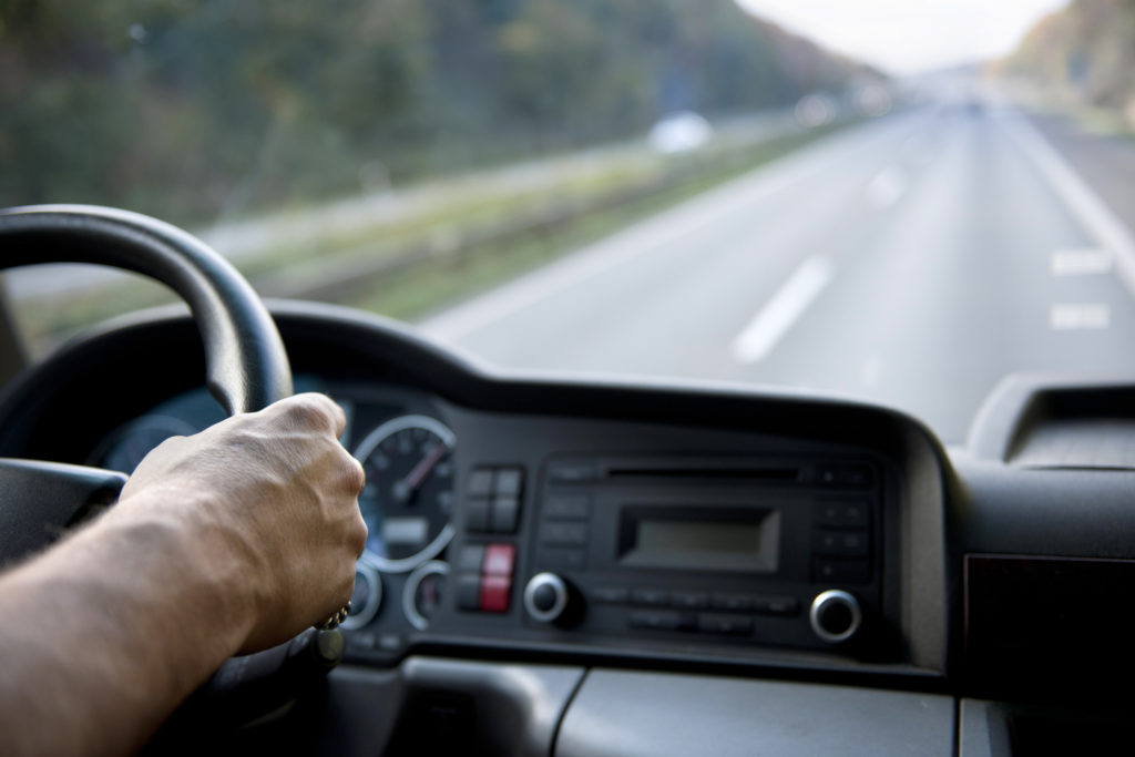 Truck driver with hands on the wheel