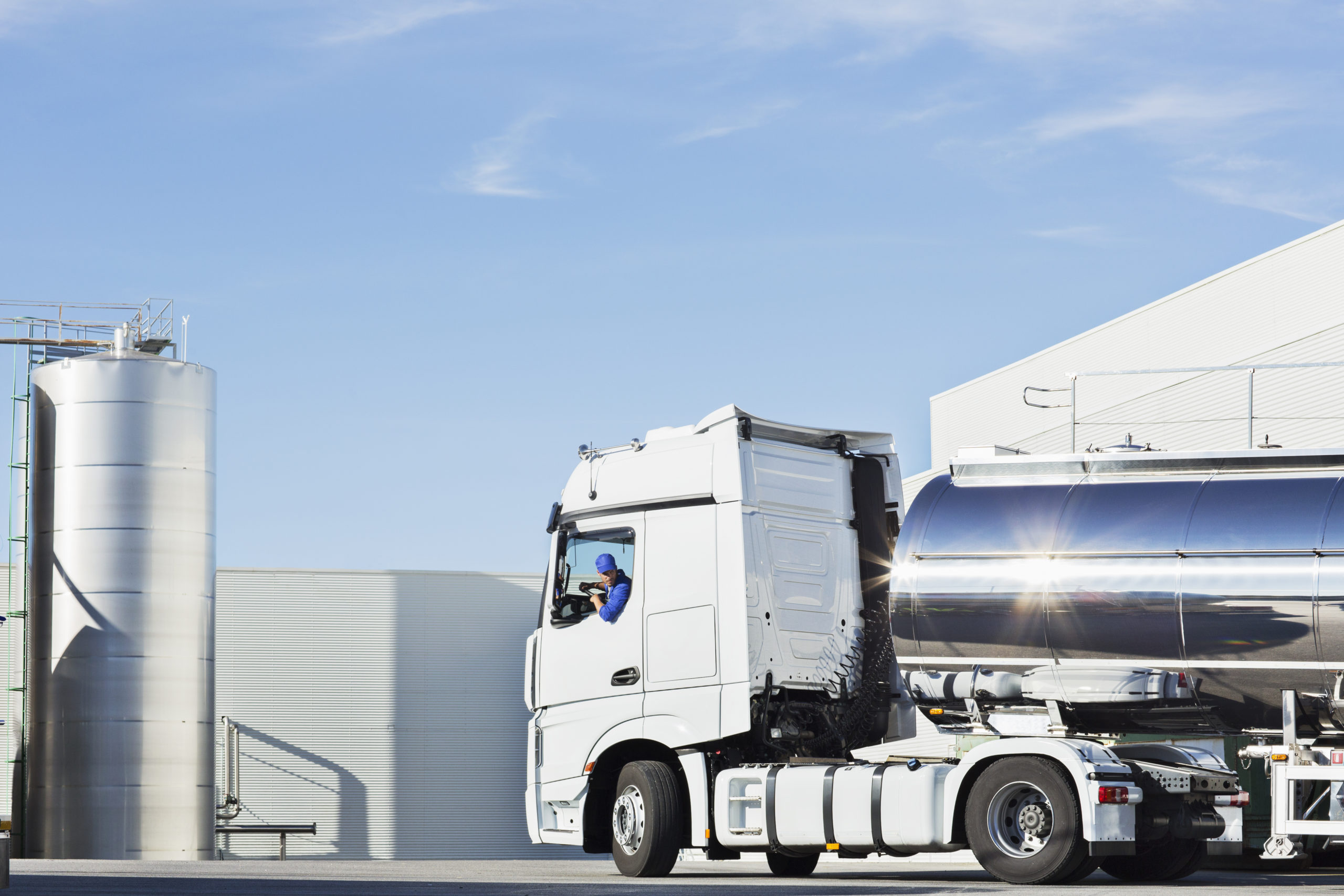 Truck driver parking his truck outside storage tower