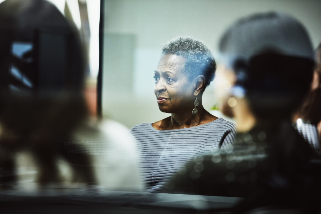 Employee listening to client presentation during meeting in office conference room