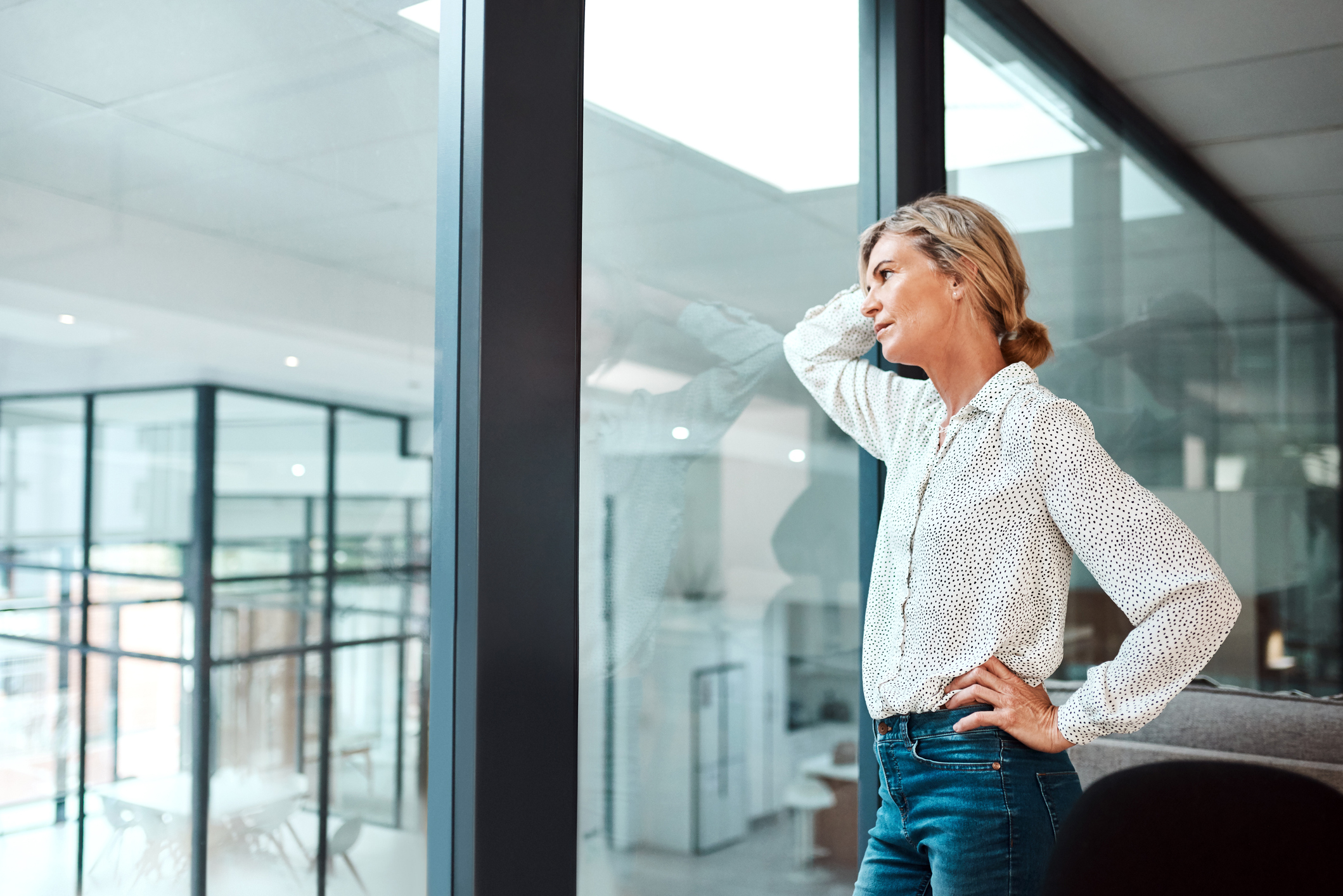 Employee looking uneasily out of the office window