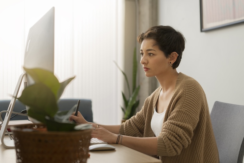 Employee working at desk looking at computer.