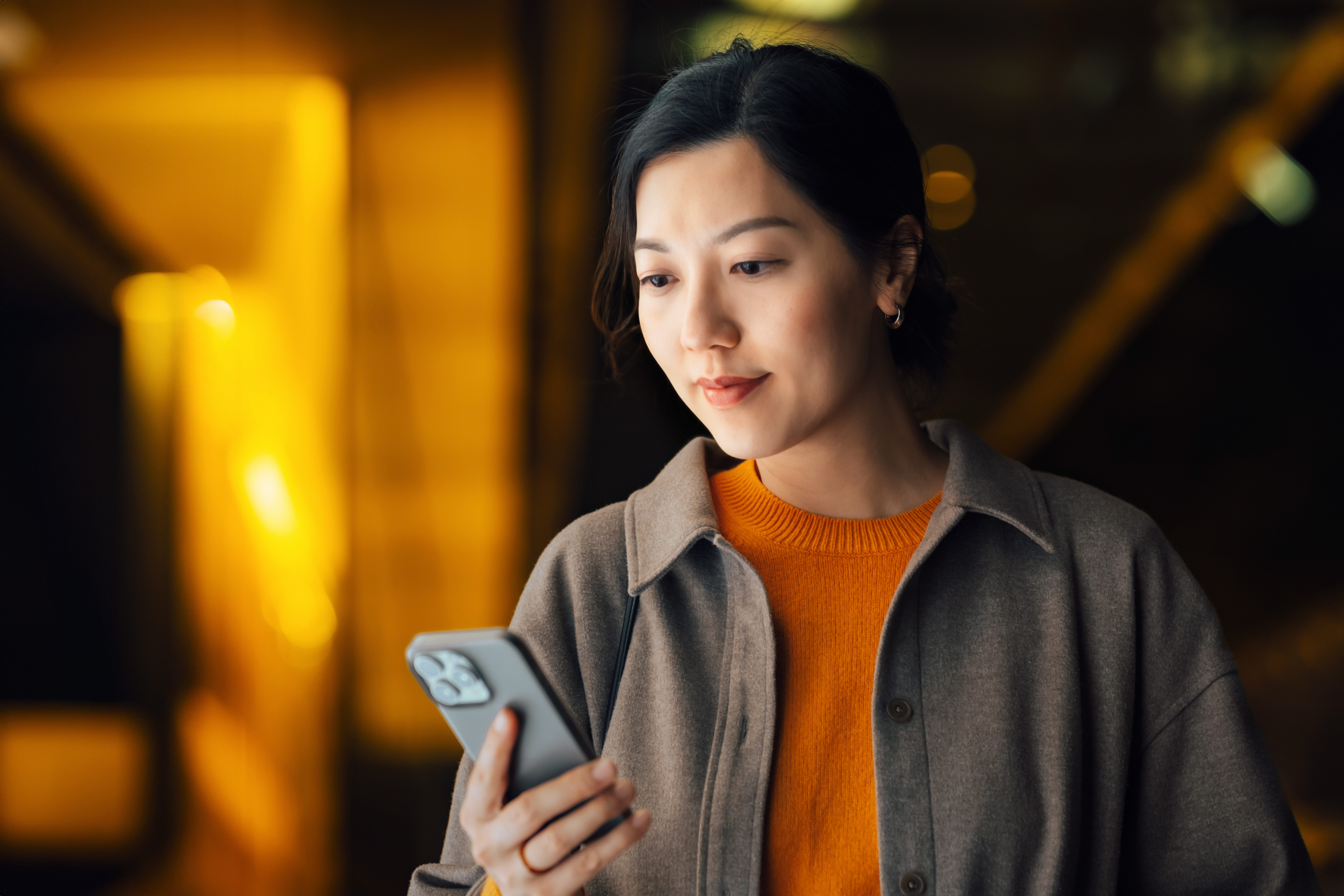 Person looking at their smartphone for foreign job searches and cross border job postings in the uk