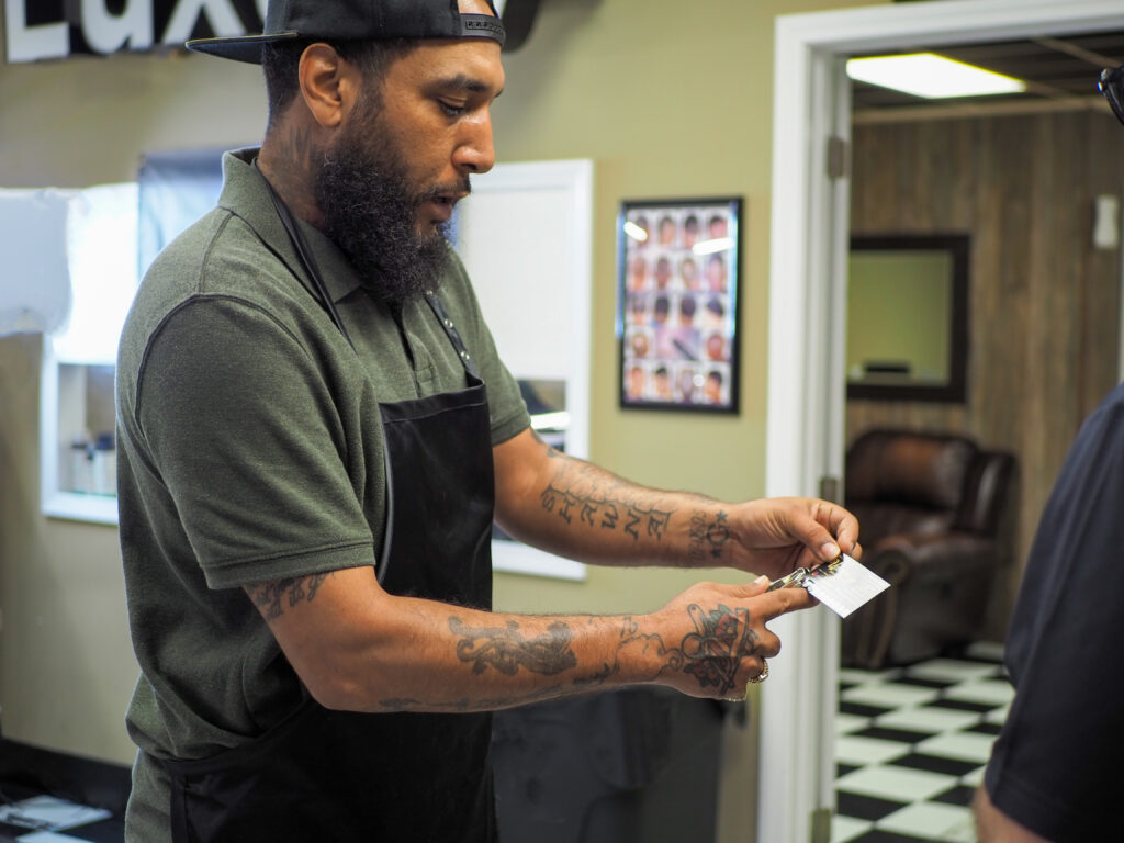 Barber punches hole in loyalty card for customer