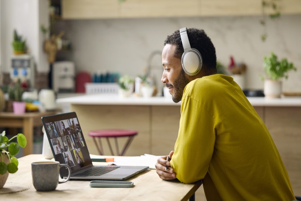 Young freelancer discussing on video conference. Entrepreneur is using laptop, working from home.