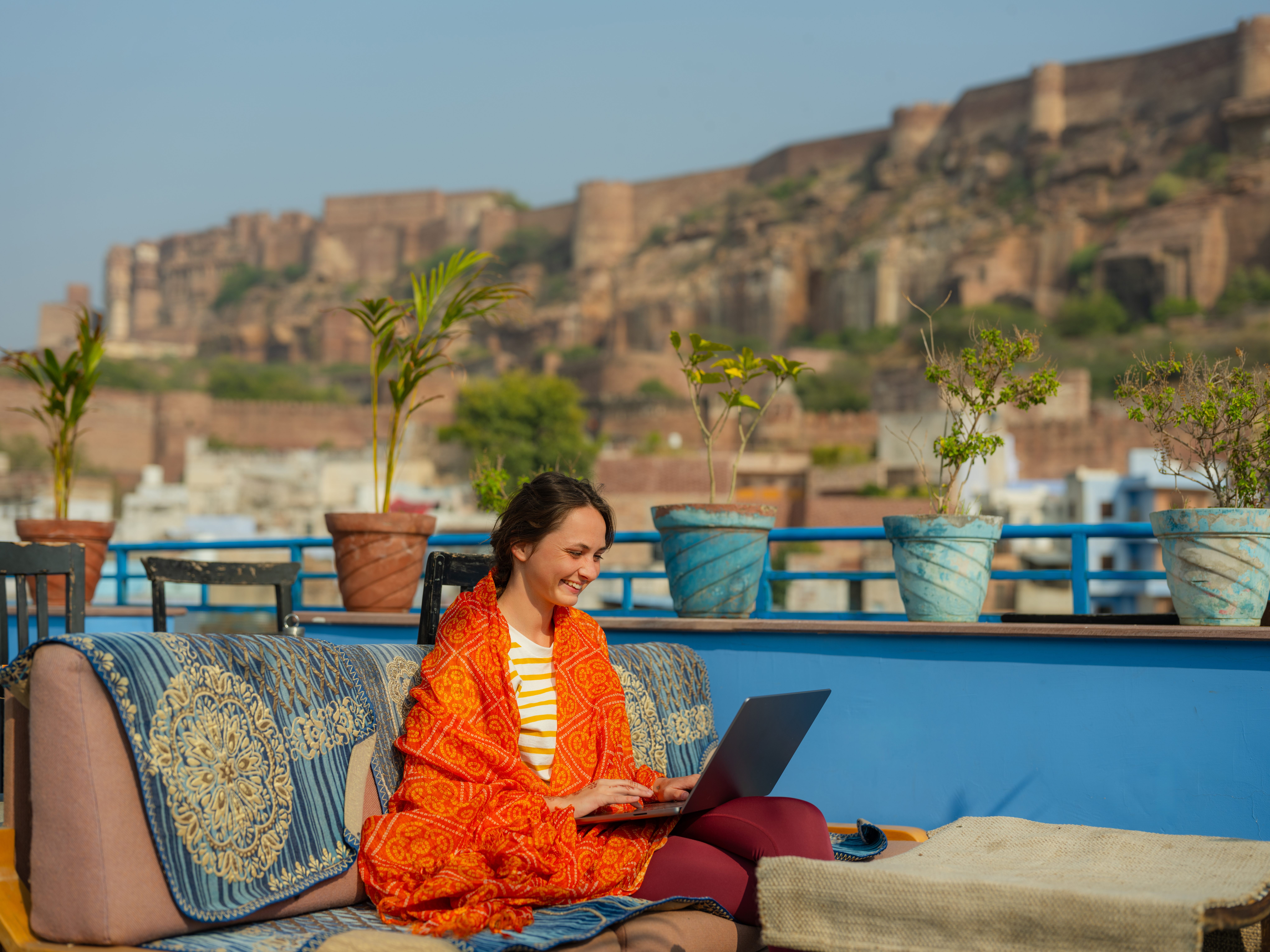 Person working with laptop on balcony