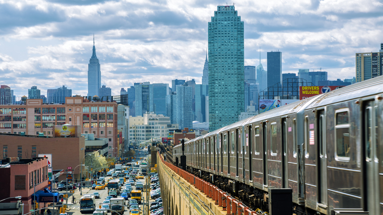 New York skyline from Queens with the number 7 subway in the foreground.