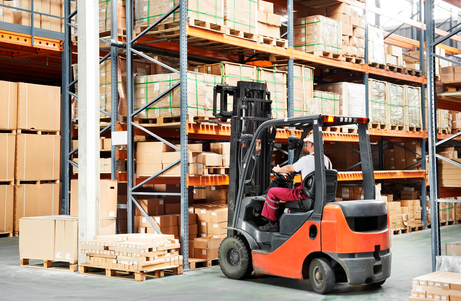 Forklift operator in action in a warehouse