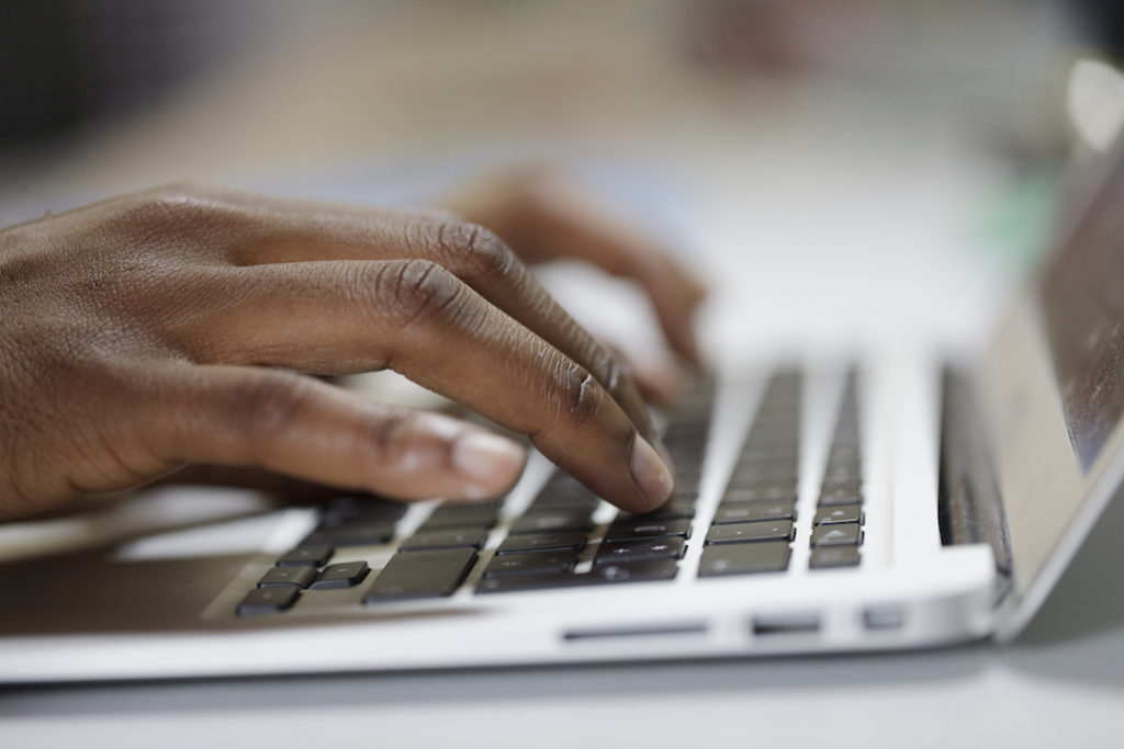 Closeup shot of person typing on Laptop.