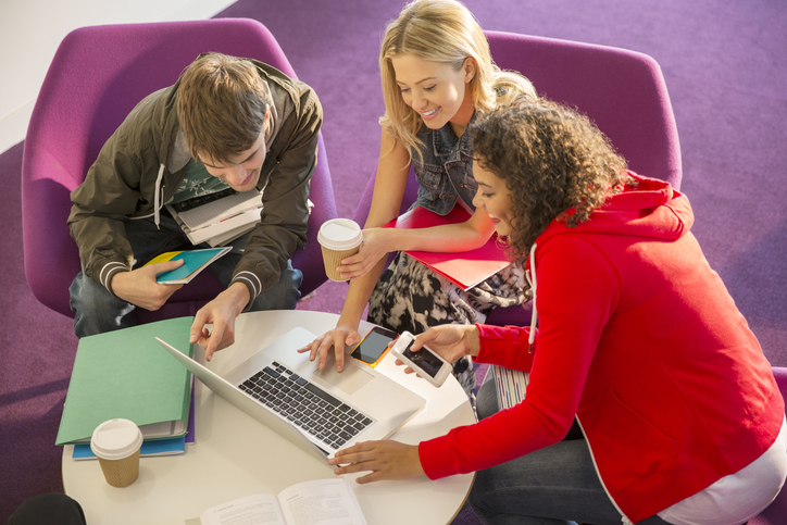 University students using laptop in lounge