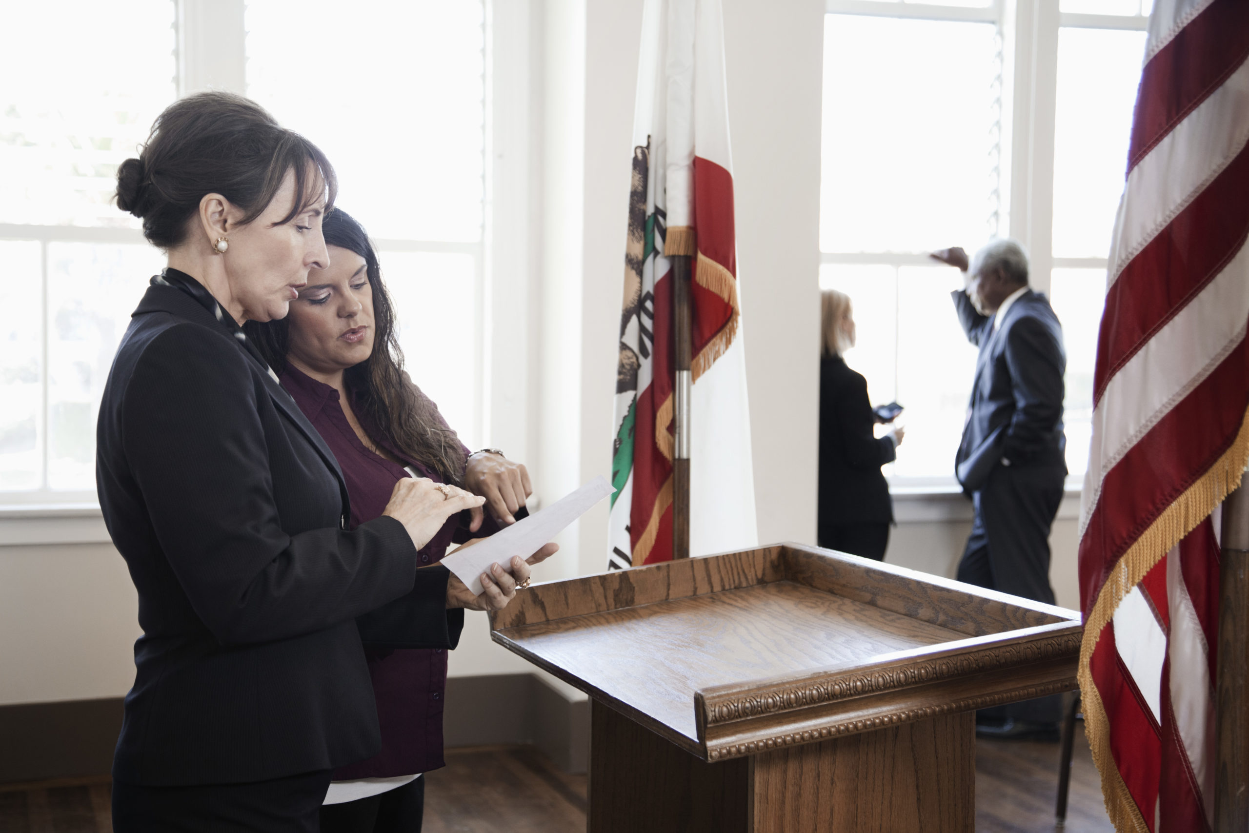 Politician preparing for speech at podium.