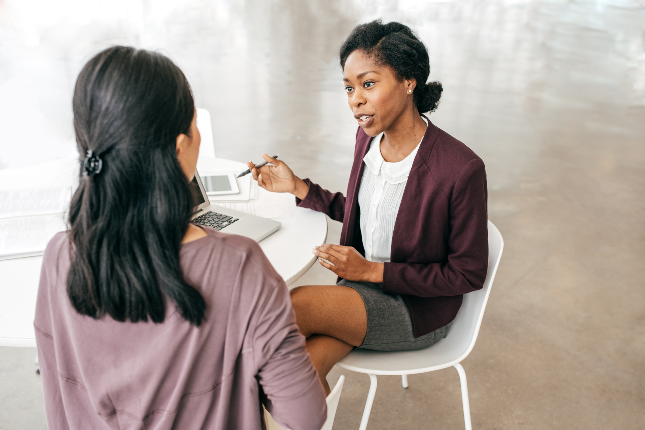 Two woman talking in on-to-one meeting.