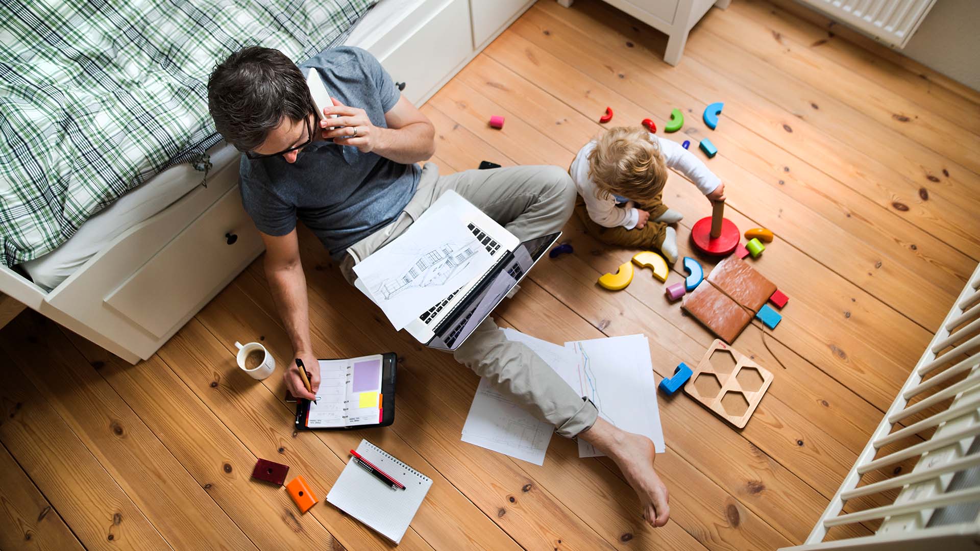 Father with his little son working from home.