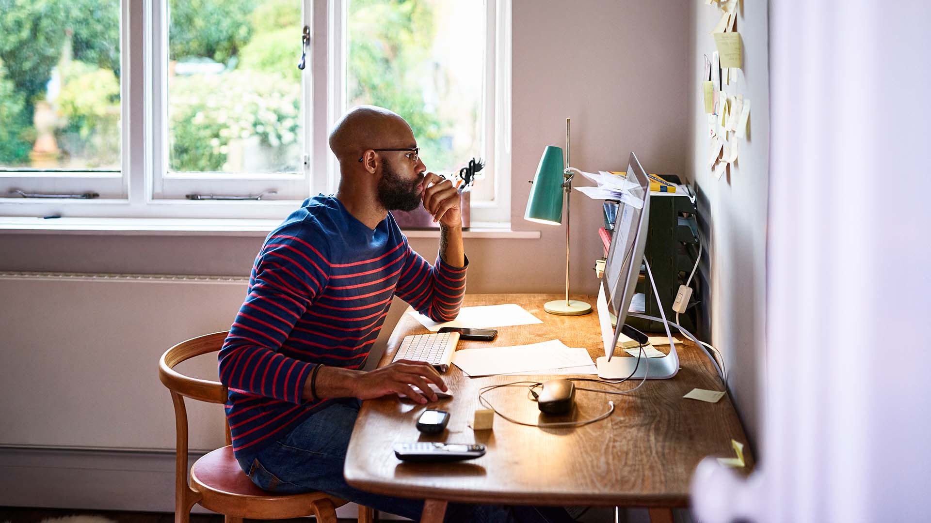 Man using computer in home office.