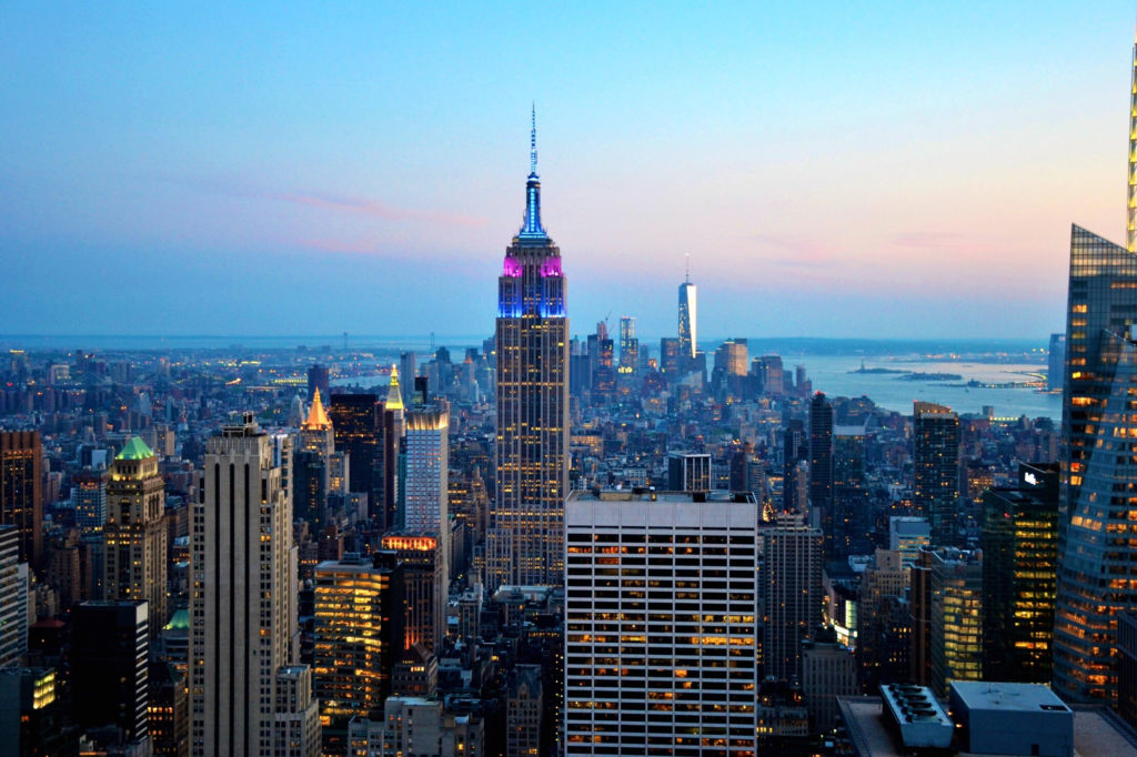 Aerial view of New York City skyscrapers at dusk.