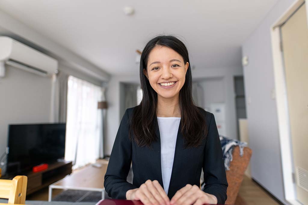 Young business woman wearing suits and joining conference call from home