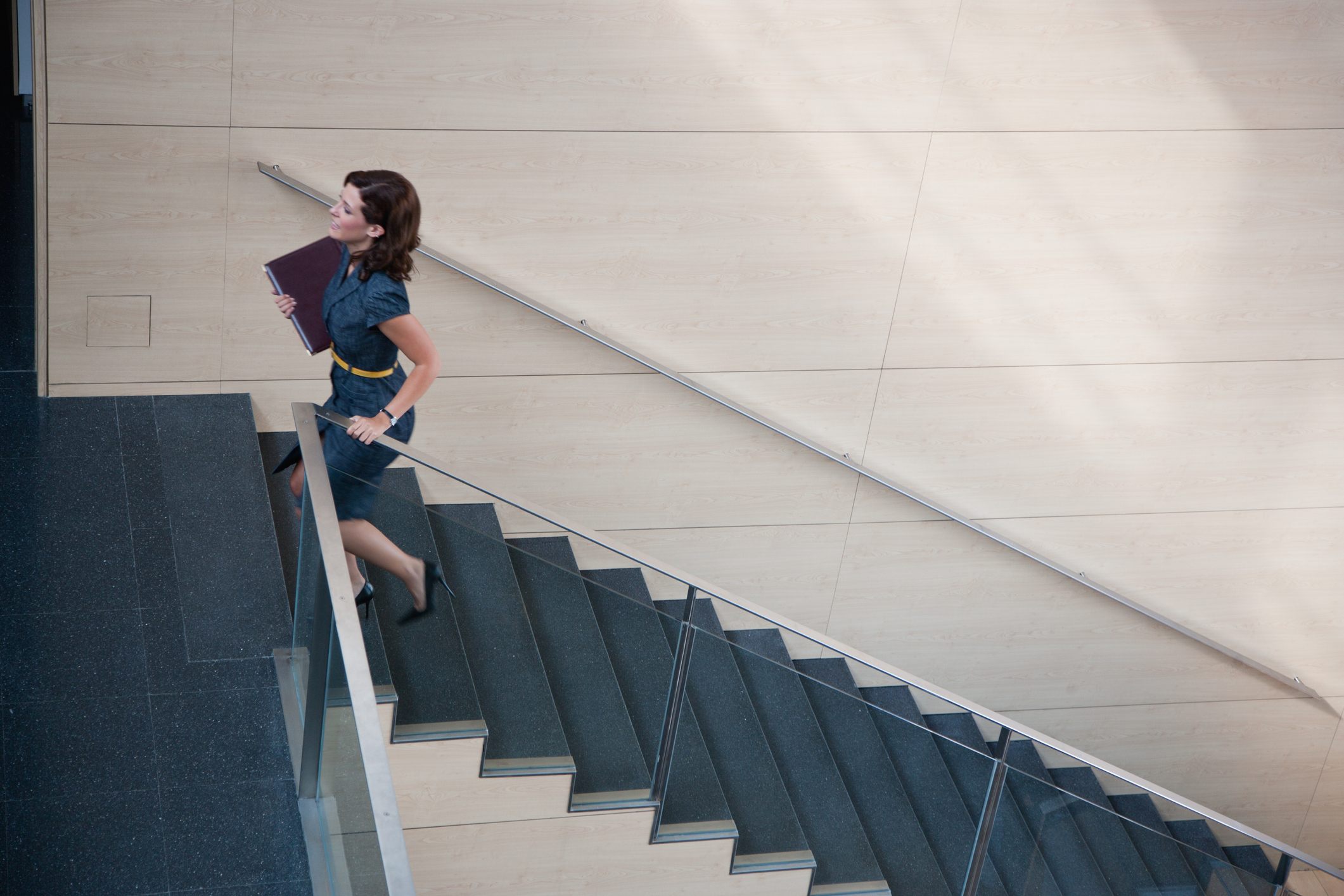 Business woman ascending office staircase