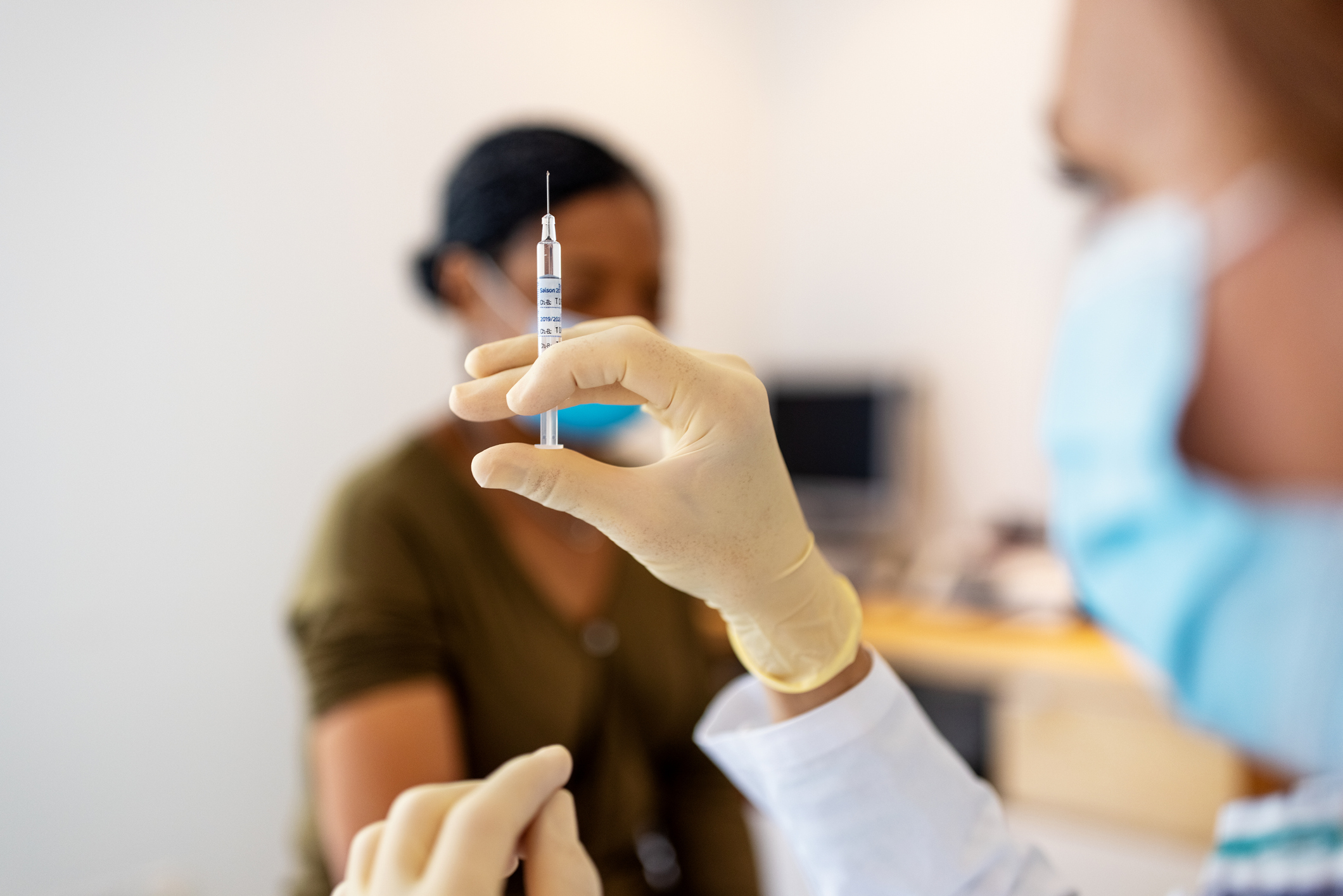 Close up of doctor preparing injection for vaccination in clinic.