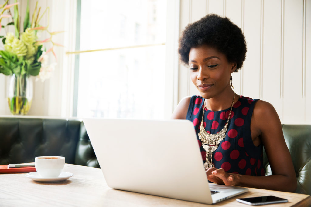 Photo of Woman using laptop at table