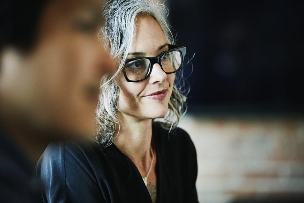 Person smiling during a business meeting.