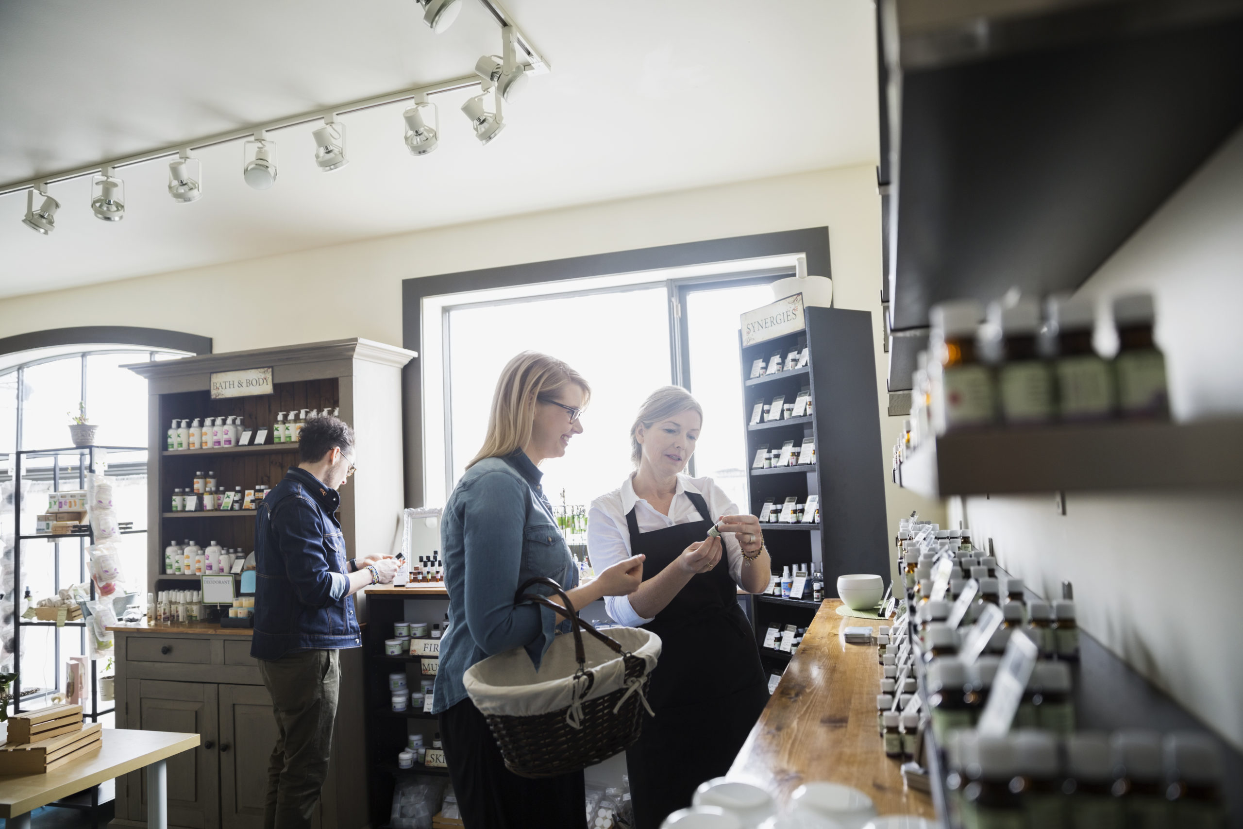 Apothecary shop owner helping customer