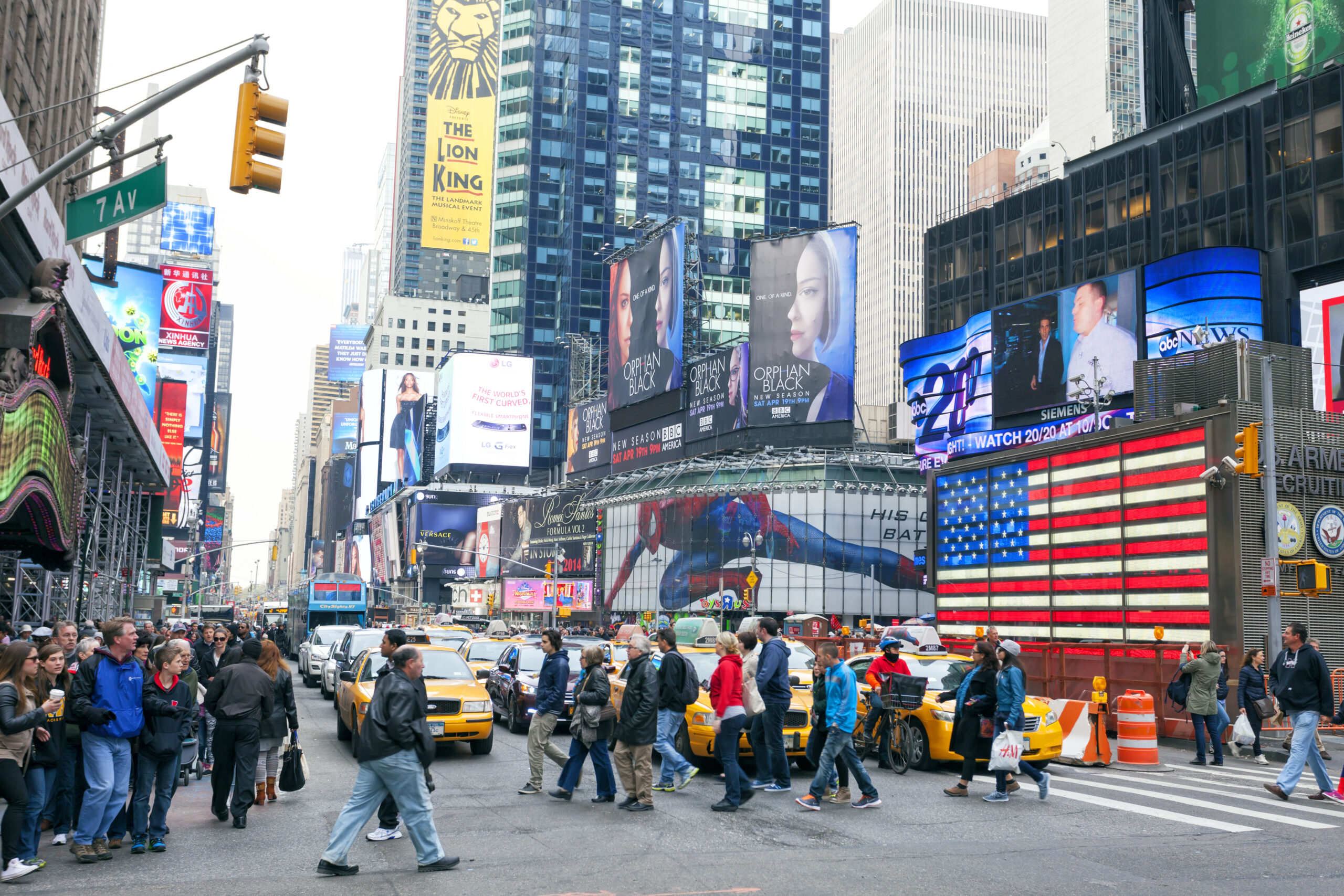 Pedestrians crossing 7th Avenue in Times Square in Manhattan, NY