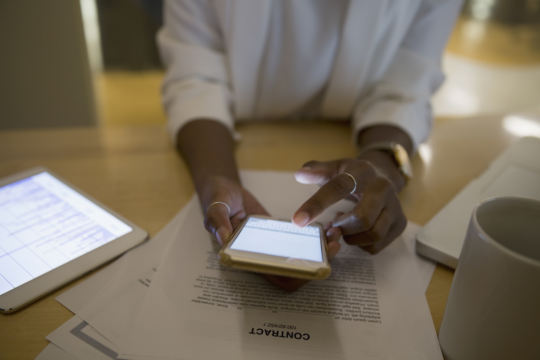 Person typing on smartphone at work