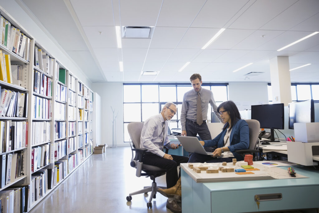 Designers using laptop in office