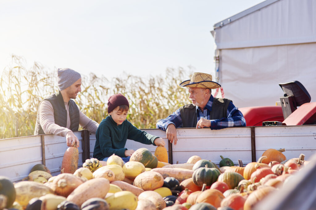 Farmers and child at pumpkin farm