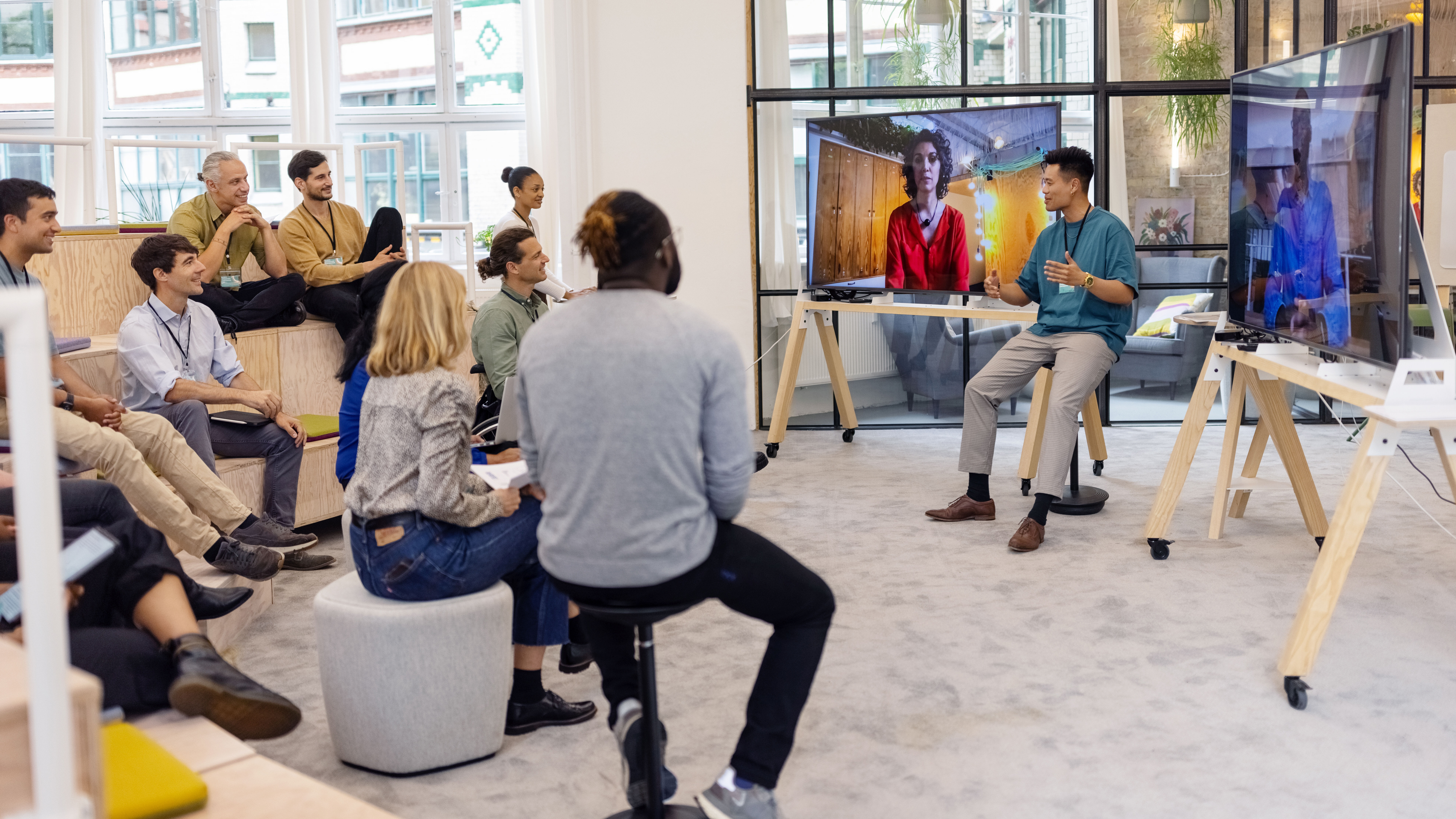 Co-workers gather for an in-person meeting in office